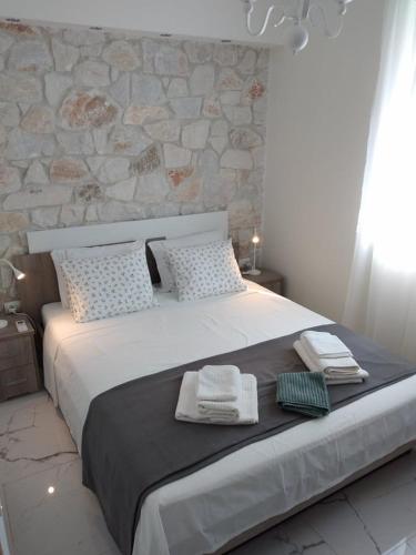 a bedroom with a large bed with towels on it at Hanioti View Apartment in Hanioti