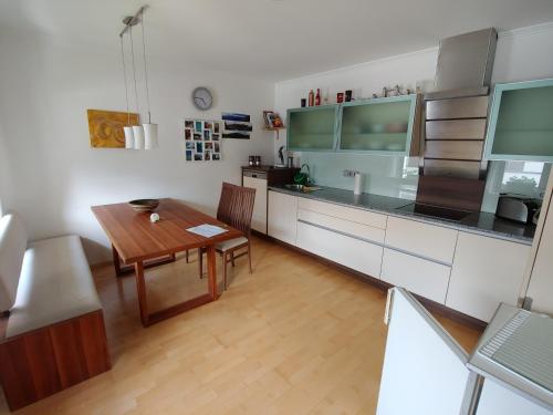 a kitchen with a table and a dining room at Villa Mountain View with waterbed in Sankt Michael im Lungau