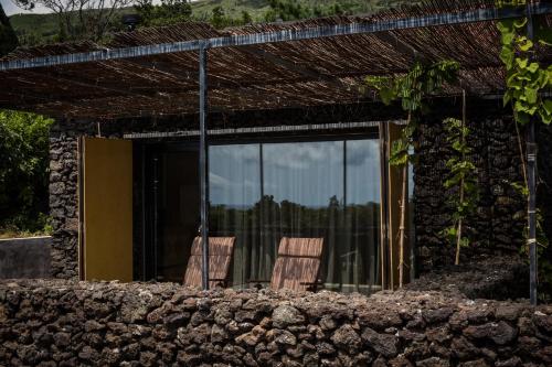 two chairs sitting in front of a building at Casas do Amarelo in São Mateus