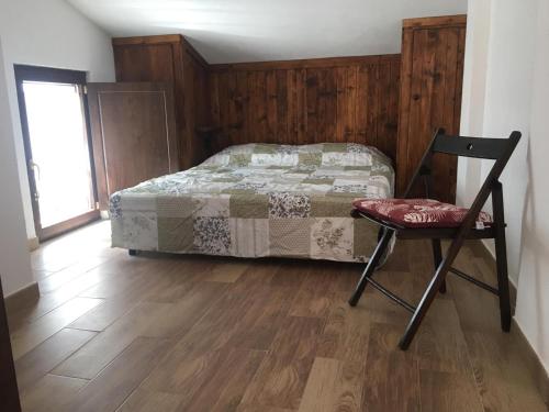 a bedroom with a bed and a chair in it at ANTICA NEVIERA HOUSE in Castel di Sangro