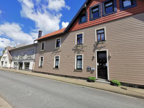a large wooden building on the side of a street at Altstadt Pension Orchidee in Wernigerode