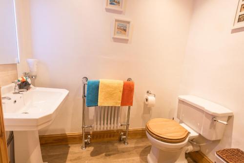 a bathroom with a toilet and a sink at Harper’s Cottage, Fence, Lancashire in Brierfield