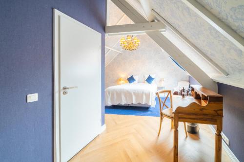 a bedroom with a bed and a desk in a room at Grand Hotel Normandy by CW Hotel Collection in Bruges