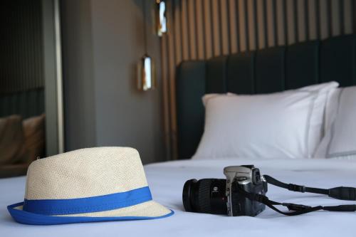 a hat and a camera sitting on a bed at HOTEL BRONTE in Istanbul
