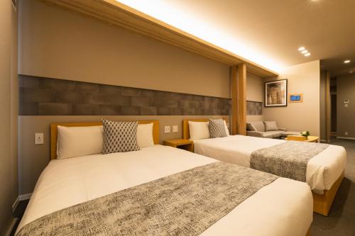 A bed or beds in a room at GRAND BASE Saiwaimachi