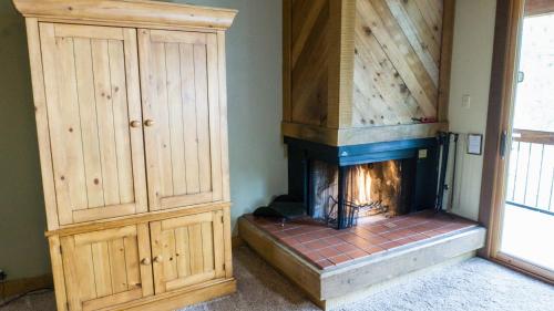 a room with a fireplace and a wooden cabinet at Indian Hills 6020 in Truckee