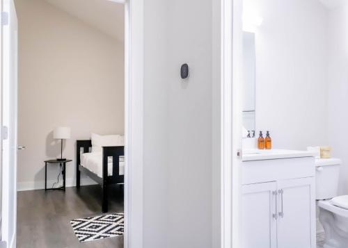 a white bathroom with a sink and a toilet at Mason Lofts at West End in Nashville