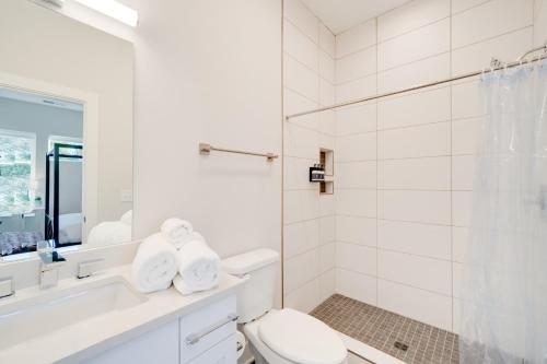 a white bathroom with a toilet and a shower at Mason Lofts at West End in Nashville
