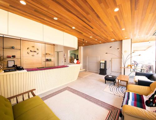 a living room with a couch and a bar at tune HIGORO in Tateyama