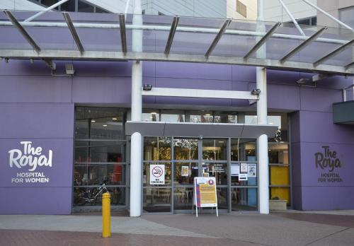 a purple building with a sign in front of it at Perouse Randwick by Sydney Lodges in Sydney
