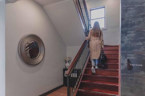 a woman walking down the stairs at Perouse Randwick by Sydney Lodges in Sydney