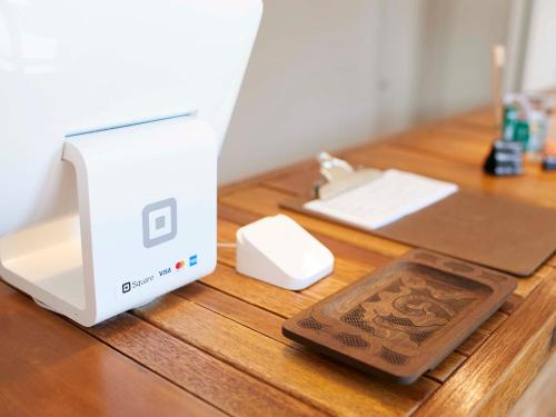 a nintendo wii on a wooden table with a box at haku hostel in Shiraoi