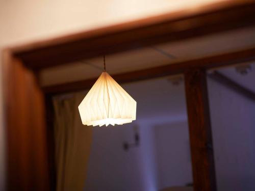 a light hanging from a ceiling in a room at haku hostel in Shiraoi