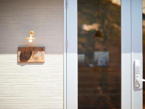 a close up of a door with a light on it at haku hostel in Shiraoi