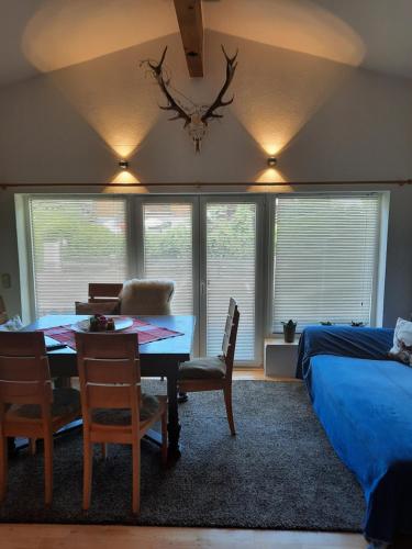 a bedroom with a table and chairs and a bed at Ferienwohnung Alpensonne in Oberstdorf