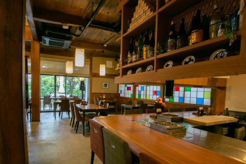 a restaurant with a bar and some tables and chairs at Kutsukake Stay Naka-Karuizawa in Karuizawa
