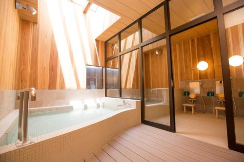 軽井沢町にあるくつかけステイ 中軽井沢の大きなバスルーム(バスタブ付)、大きな窓が備わります。