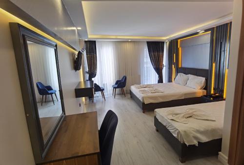 a hotel room with two beds and a table and chairs at Sirkeci Quietness Hotel in Istanbul