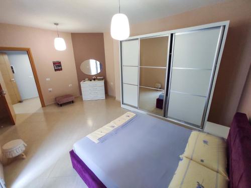 a living room with a large glass wall at NYC Modern & Spacious Apartament 5 min from seaside in Orikum