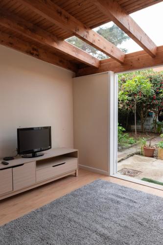 a living room with a flat screen tv and a window at Ninho @ Francos in Porto