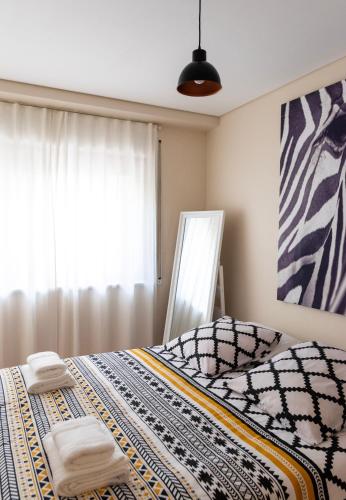 a bedroom with a bed with towels on it at Ninho @ Francos in Porto