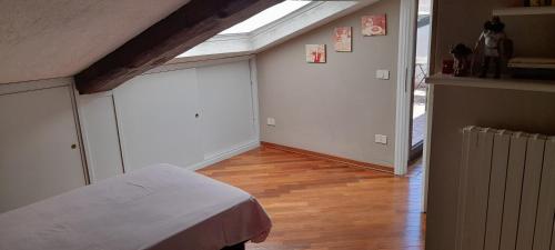 a bedroom with a bed and a skylight at Corte Cavour. Una mansarda nel cuore della città in Ravenna