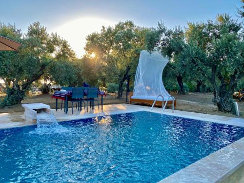 a swimming pool with a water slide in a backyard at Lamin House in Sirince