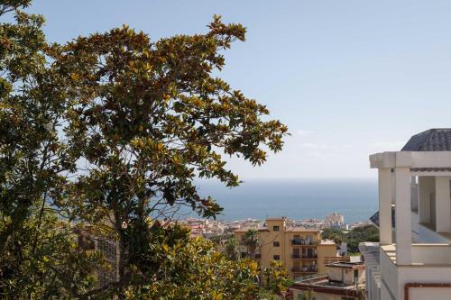a view of the ocean from a city at Hotel Sakura in Torre del Greco
