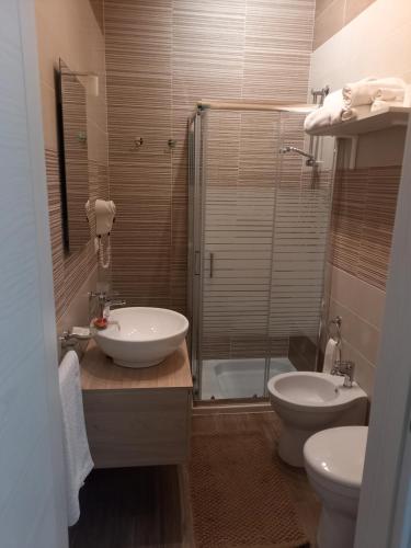 a bathroom with a sink and a toilet and a shower at B&B villa brezza marina in Sant'Isidoro