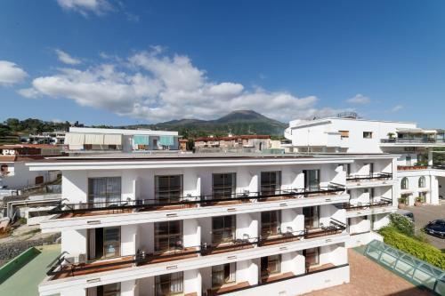 an aerial view of a white building with balconies at Hotel Sakura in Torre del Greco