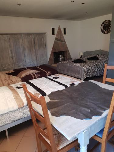 a room with two beds and a table with chairs at les gites de l'océan indien in Batzendorf