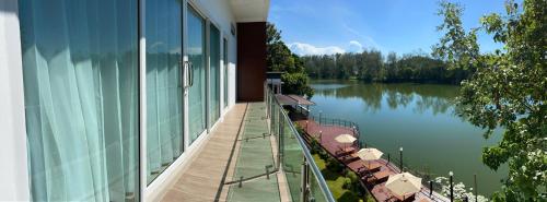 a balcony of a building with a view of a lake at Pure Laguna Residence by Nice Sea Resort in Srithanu