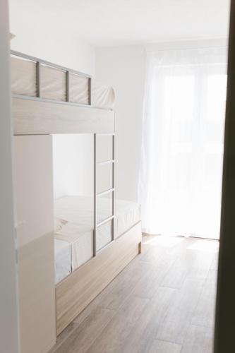 ein weißes Zimmer mit Etagenbetten. in der Unterkunft Apartmani Toma in Pakoštane