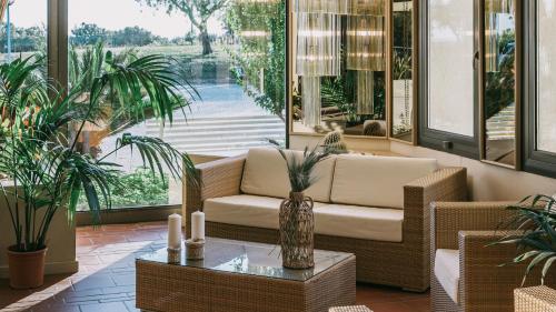 a lobby with a couch and a table with plants at MClub Alicudi in Sciacca