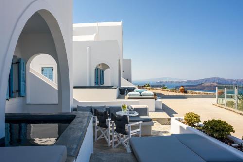a large white building with a patio area at Kalestesia Suites in Akrotiri