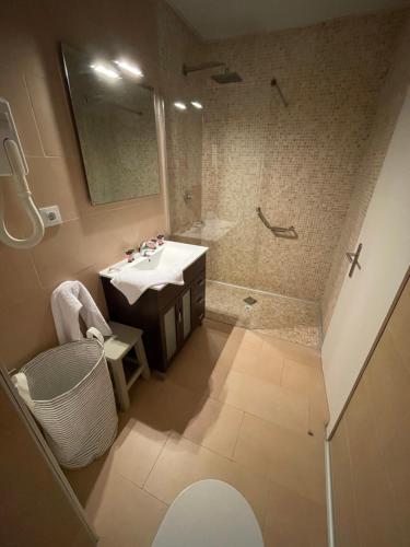 an overhead view of a bathroom with a sink and shower at Mas Boronat Resort in Salomó