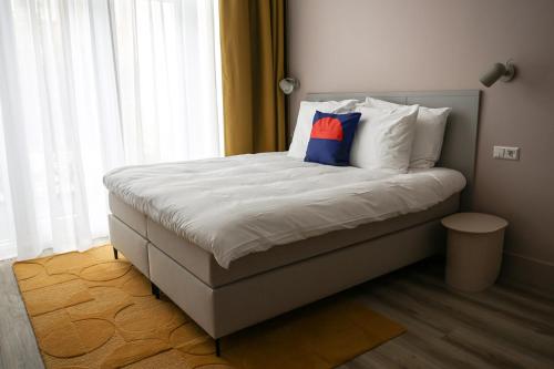 a bed with a pillow on it in a bedroom at Hotel Bries Den Haag - Scheveningen in The Hague