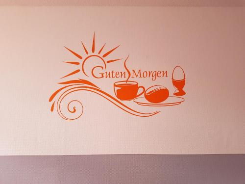 a logo for a coffee shop with a sun and two cups at Hotel Citymaxx in Rostock