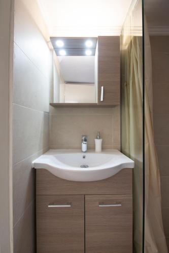 a bathroom with a sink and a mirror at Seaview studio in Iraklitsa