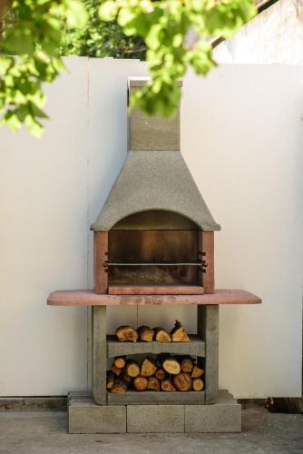 a wood fired oven with a pile of bread at Aurora Seaview Apartment in Mlini