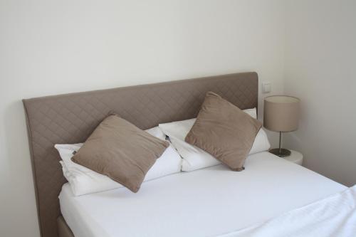 a bedroom with a bed with white sheets and pillows at Apartment 1 in Mannheim