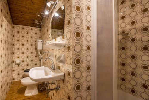 La salle de bains est pourvue d'un lavabo et de toilettes. dans l'établissement Apt Hofer Silena, à Villabassa