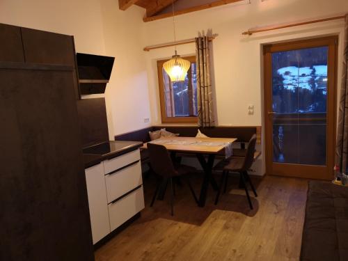 uma cozinha e sala de jantar com mesa e cadeiras em Haus Kristall em Alpbach