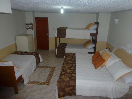 a hotel room with two beds in a room at Hotel San Nicolas in Bucaramanga