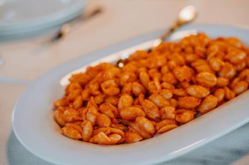 a white bowl filled with a pile of food at Resort Fior di Sardegna in Posada