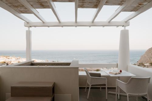 a dining room with a view of the ocean at Mon Signor in Kamari