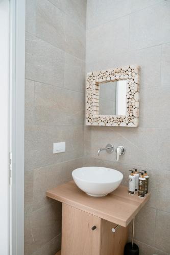 a bathroom with a white sink and a mirror at Mon Signor in Kamari