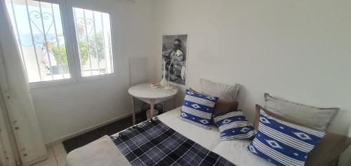 a bedroom with a bed with blue and white pillows at Casa Lento in Tías