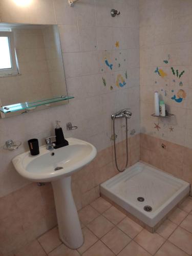a bathroom with a sink and a shower at Ostria in Preveza