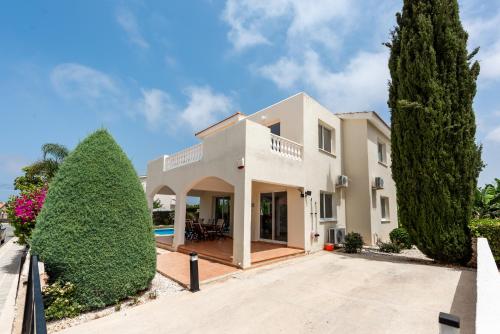 a villa with a swimming pool and two trees at Villa Alysia by Ezoria Villas in Coral Bay